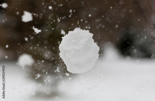 Snowball flies into the camera. The snowball shatters into snowflakes photo