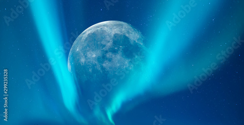 Northern lights (Aurora borealis) in the sky over Tromso with full moon, Norway 