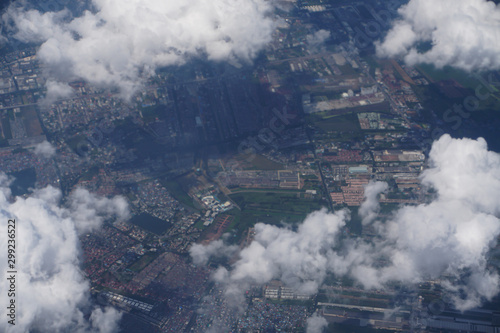 The aerial view of city through the cloud 