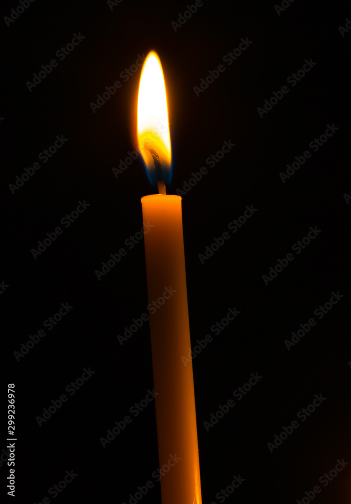 Green birthday candle yellow lights burning in the dark and black background Green birthday candle yellow lights burning in the dark and black background