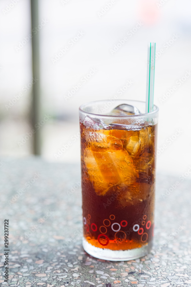Cola in glass with ice on table Cola in glass with ice on table