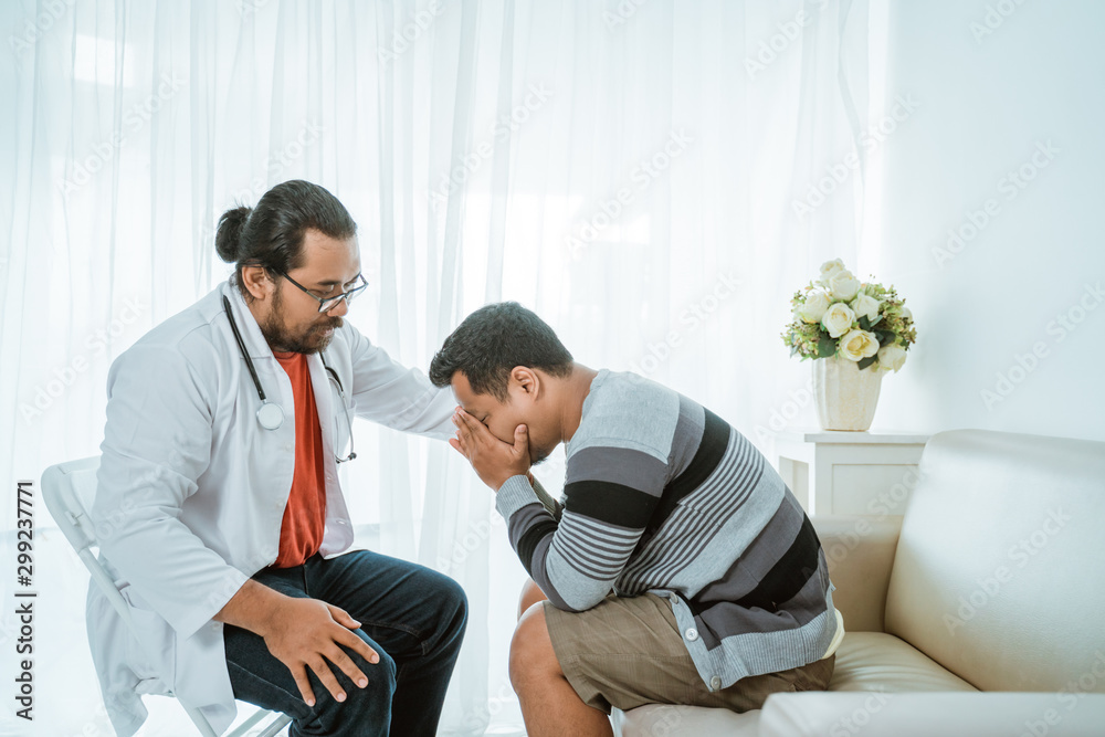 portrait of depress patient consulting with his doctor in his office portrait of depress patient consulting with his doctor in his office