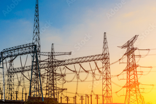 High voltage electricity tower at sunset.substation industrial background.
