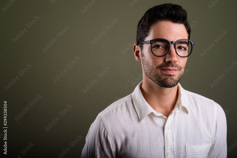 Portrait of young handsome businessman wearing eyeglasses