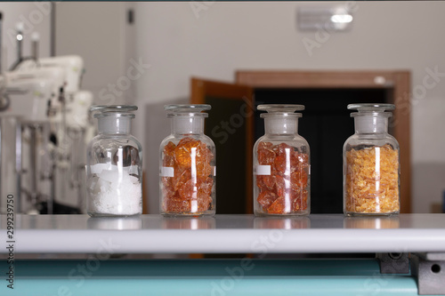 Crystals in bottles, substance in corked flasks close up