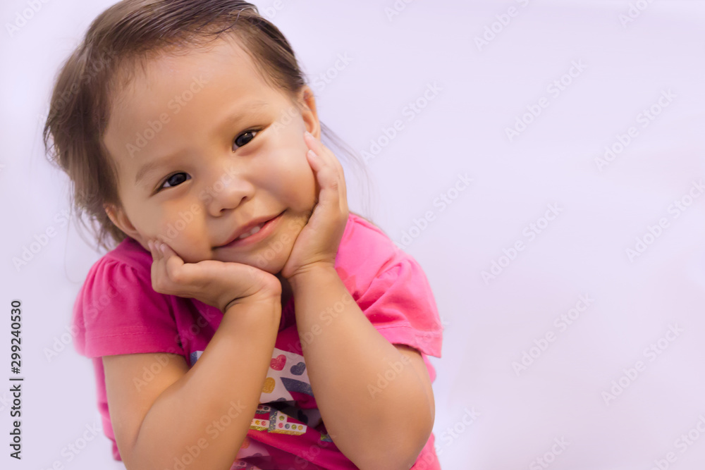 A cute little girl looking into the camera, smiling. Copy-space. A cute little girl looking into the camera, smiling. Copy-space.