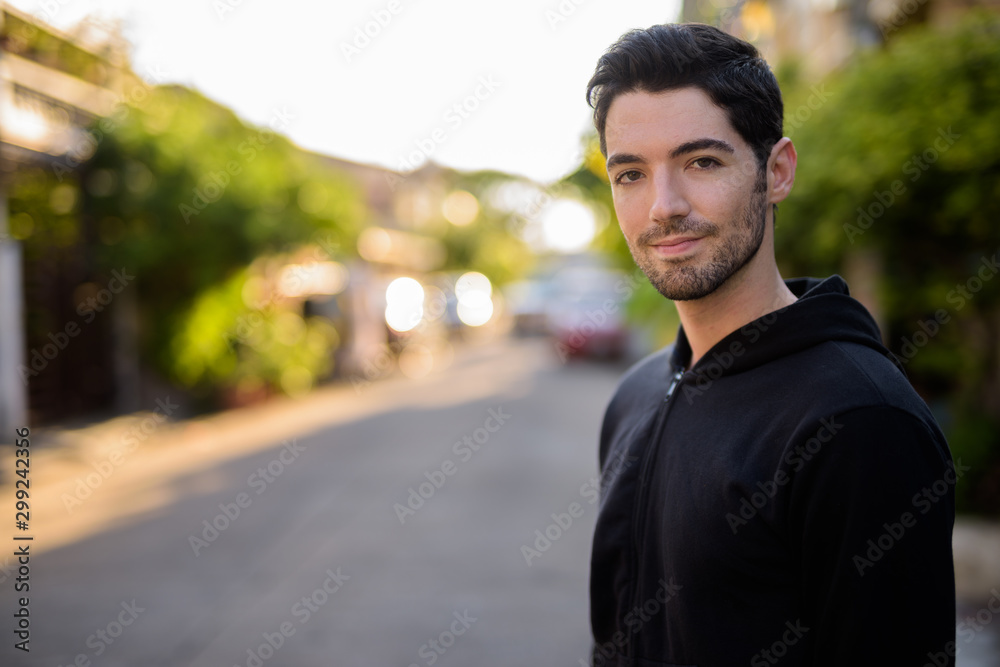 Fototapeta premium Young handsome man with stubble beard outdoors