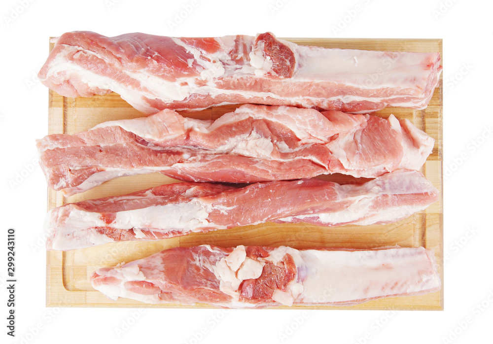 Pieces of fresh pork meat on a wooden cutboard isolated on white background. View from above