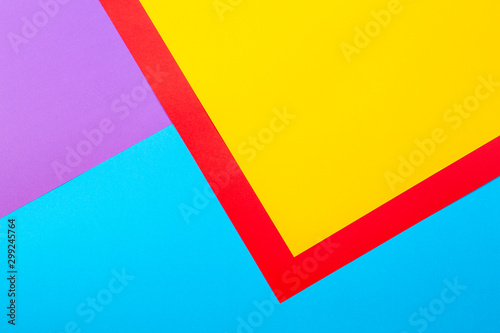 Color papers geometry flat composition background with yellow red violet and blue tones