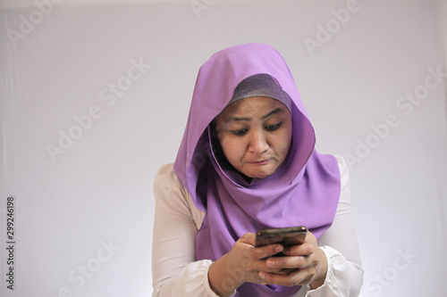 Muslim Woman Angry While Reading Text Message on Smart Phone