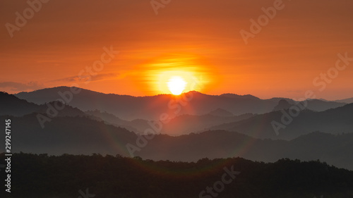 Fototapeta Naklejka Na Ścianę i Meble -  Morning mist covered on hill after sunrise at tropical forest. Thailand