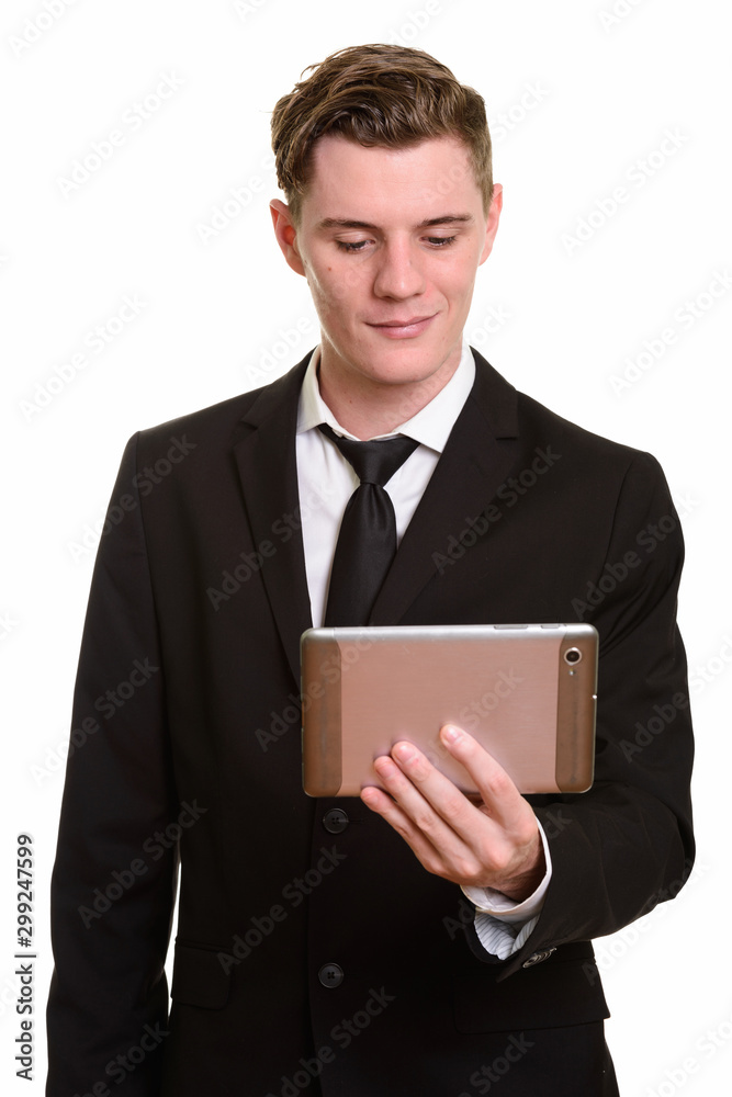 Young handsome blonde businessman in suit using digital tablet Young handsome blonde businessman in suit using digital tablet