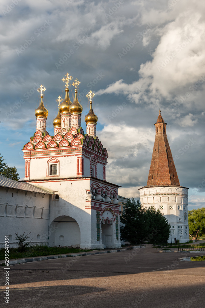 The main entrance and watchtower in the rays of the setting sun. Russian shrines. Joseph-Volotsky Monastery in Teryaev. Moscow region, Teryaevo.