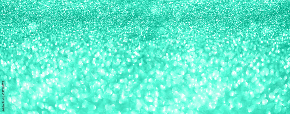 Obraz premium Gold glitter banner. Shiny abstract textured background with golden lights, bokeh. Trendy green and turquoise color. Christmas, new year conceptin mint color
