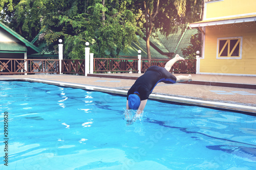  young woman jumping into the swimming pools