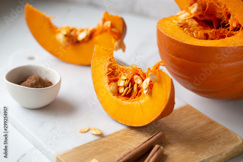 pumpkins with cinnamon sticks on marble backgrund