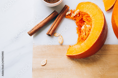 pumpkins with cinnamon sticks on marble backgrund photo