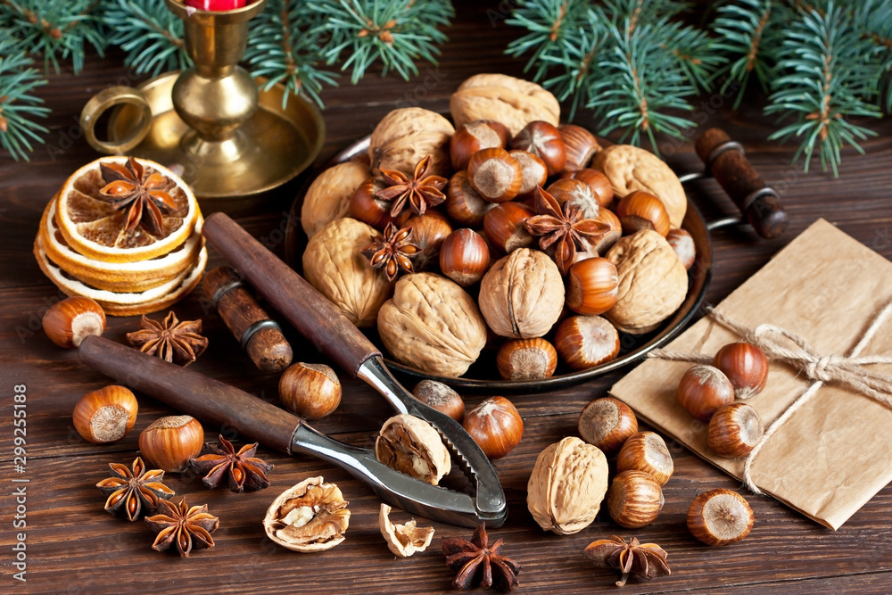 Composition with nuts and nutcracker on wooden background