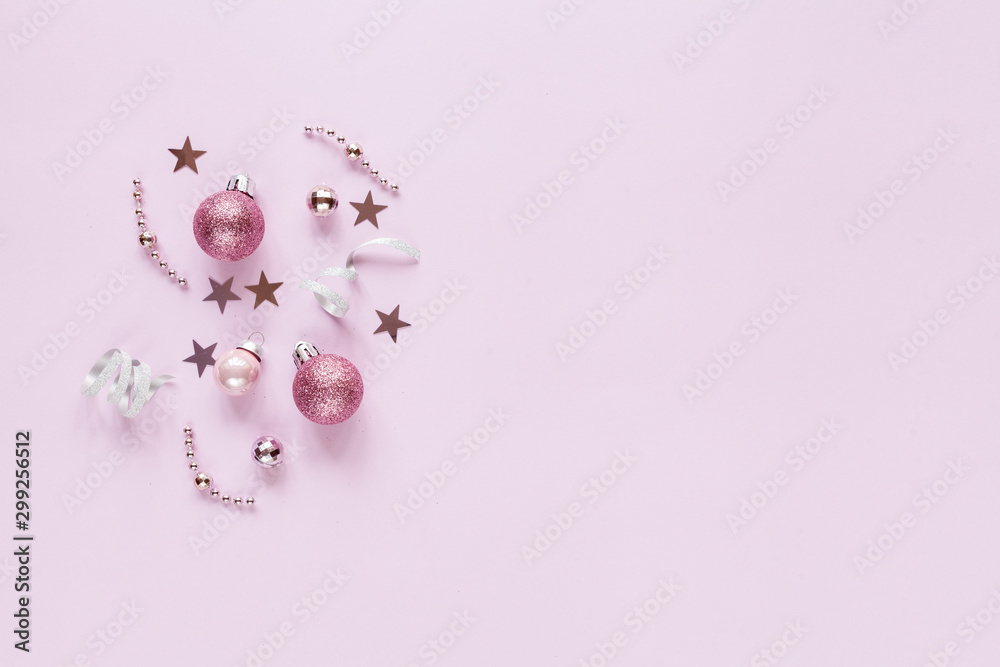 Pink background with christmas decor: balls, stars, festive. Flat lay.