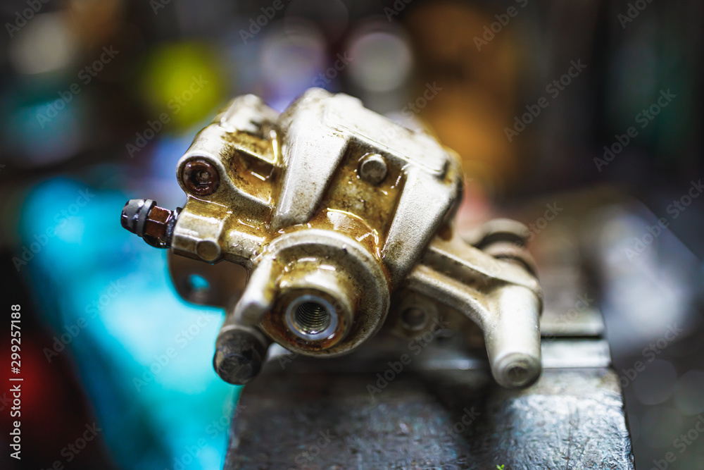 ATV hydraulic disc brake caliper system repair in old garage ATV hydraulic disc brake caliper system repair in old garage