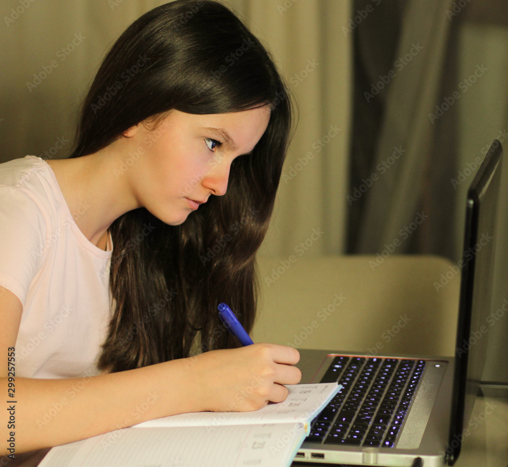 Teen girl using laptop does a search on the internet to do homework Teen girl using laptop does a search on the internet to do homework