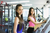 Teen girls training. Two beautiful teenage in the gym