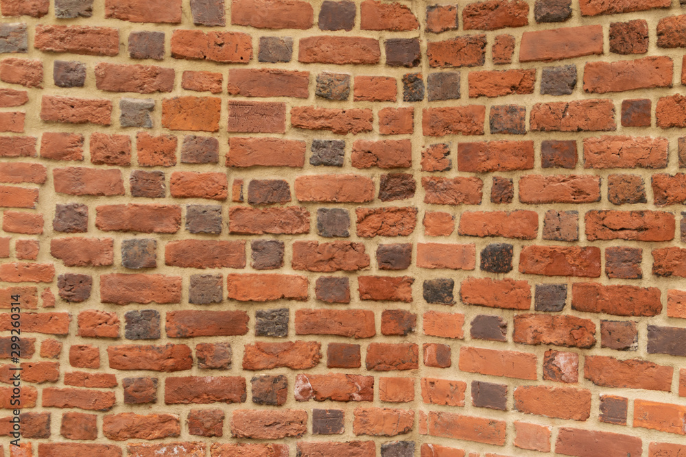 Old red brick fortress wall with gray cement mortar textute