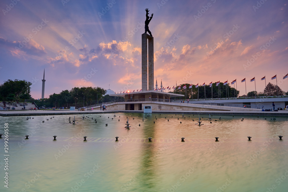 West Irian Liberation Monument in Jakarta in the sunset with ray of light, Jakarta, Indonesia