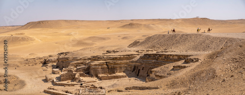 Canvas Print Panoramic view of the Giza Plateau with pharaohs ruins and camel riders, Cairo,