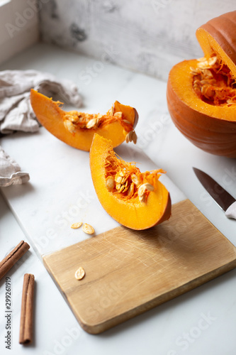 pumpkins with cinnamon sticks on marble backgrund photo