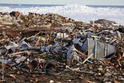Fuel drums and piles of scrap metal waste in the Arctic