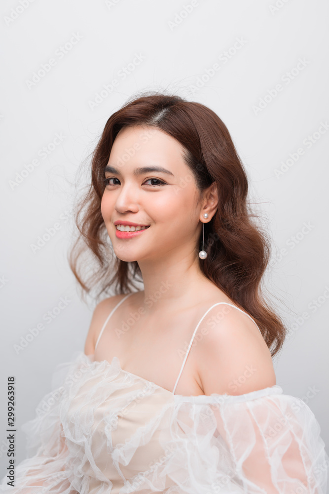 Beautiful smiling young asian woman with clean, fresh, glow, and perfect skin in white dress Beautiful smiling young asian woman with clean, fresh, glow, and perfect skin in white dress