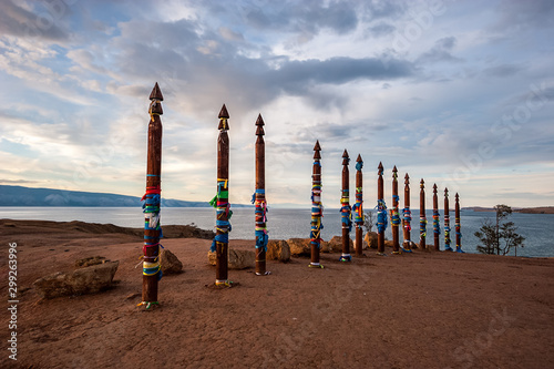 Sacred pillars with tied ribbons on Cape Burhan of Olkhon Island. Buryat traditions. Shamanistic rites of Lake Baikal.