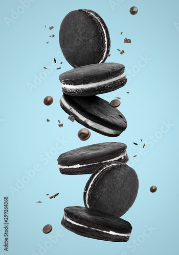 Falling chocolate cookies on color background