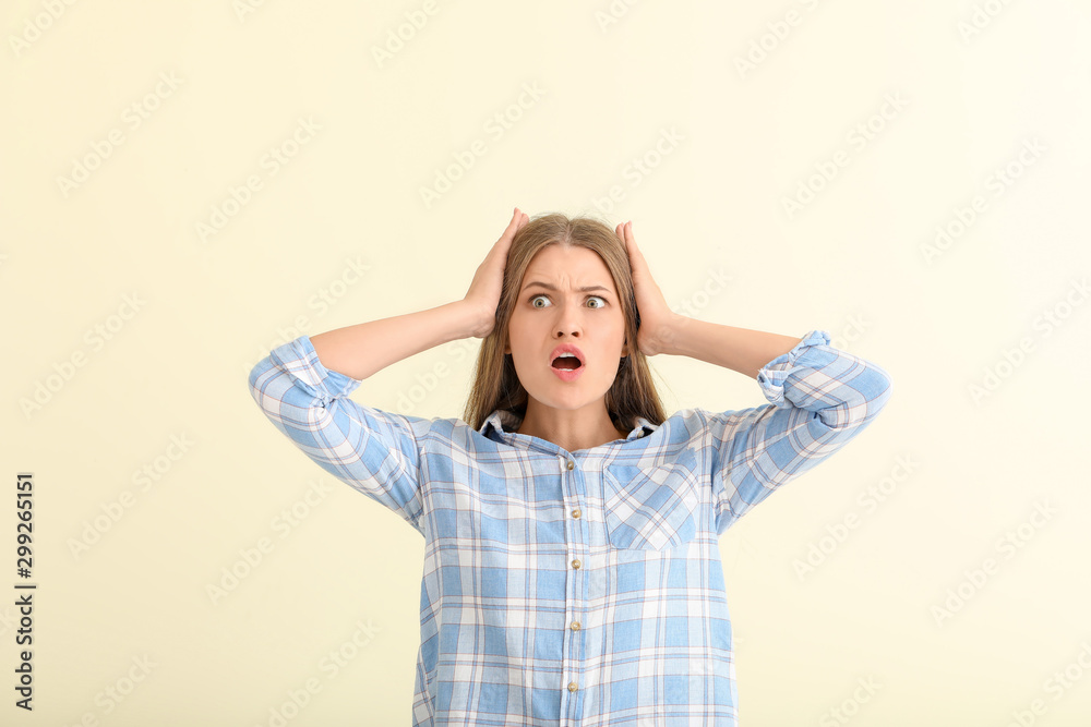 Surprised young woman on light background Surprised young woman on light background