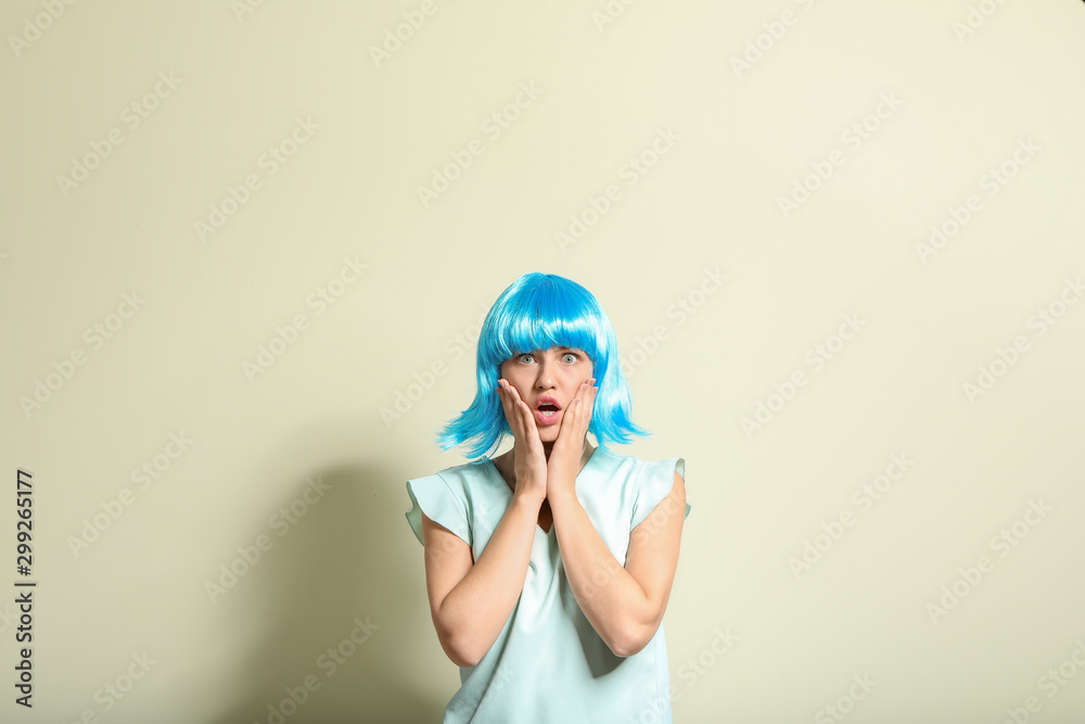 Surprised young woman in bright wig on light background Surprised young woman in bright wig on light background