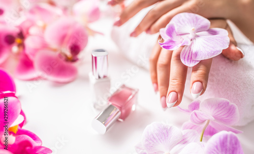 Beautiful nail manicure with decoration from pink orchid