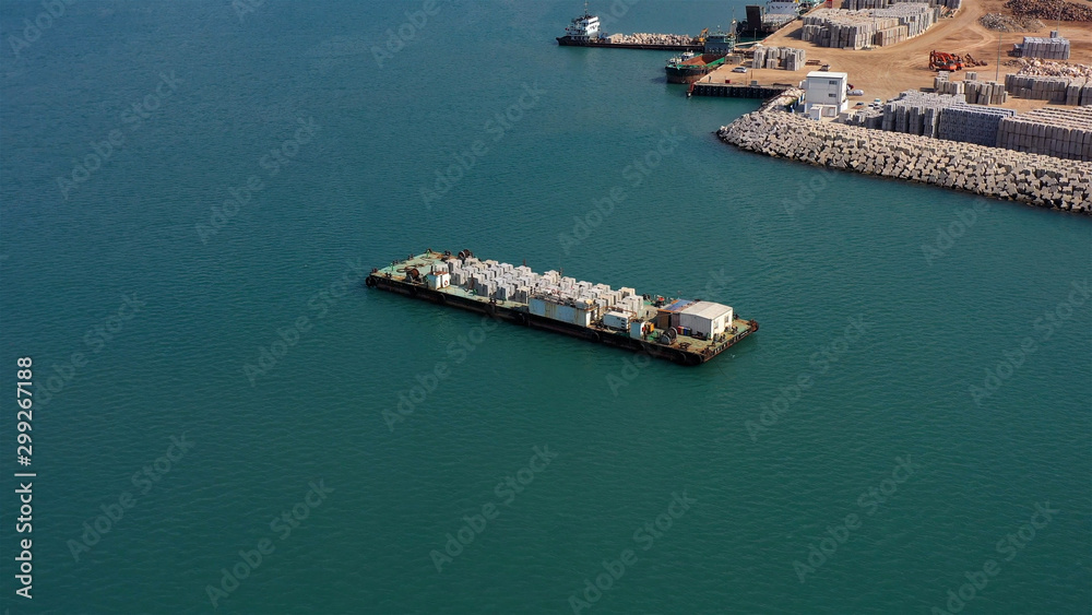 Drone view over Large barge with construction materials in Mediterranean sea new Harbor