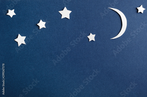Obraz na płótnie Moon and stars on blue background top view. Night sky objects with shadow close up. Decorative backdrop. Childish applique, homemade postcard. Starry heaven. Kid bedtime, nighttime concept. w salonie