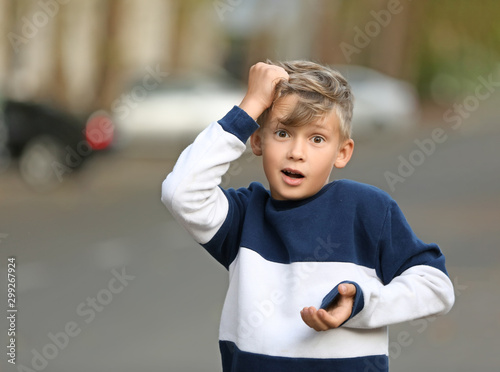 Stressed little boy walking...