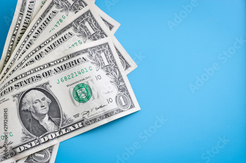 One dollar bills on a blue background. American currency.