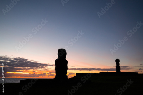 Some giant statues of Easter Island at sunset. The moai of the Ahu Tahai Ceremonial Complex, Hanga Roa, Easter Island, Chile