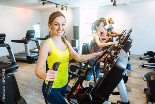 Caucasian woman and her friends doing step training in gym