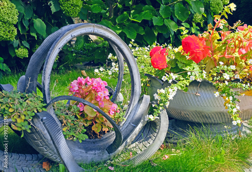DIY idea to recycle of tire used with flowers or plant in old rubber painted pastel color in garden home.