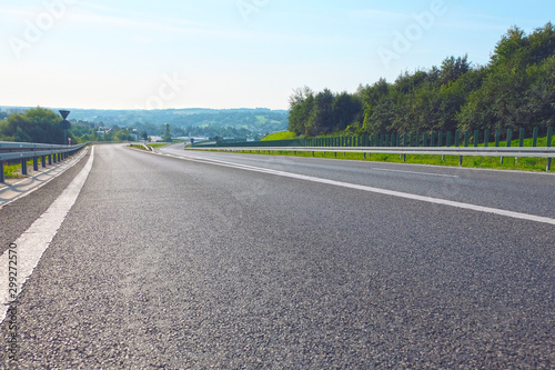 asphalt road under the blue sky in Europe, with nice landscape on the background