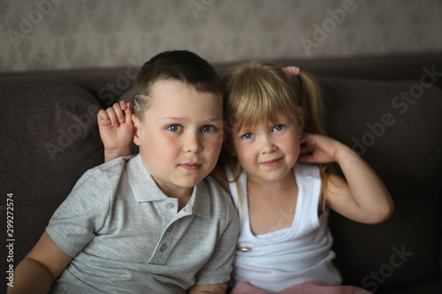 siblings brother and sister watch TV together