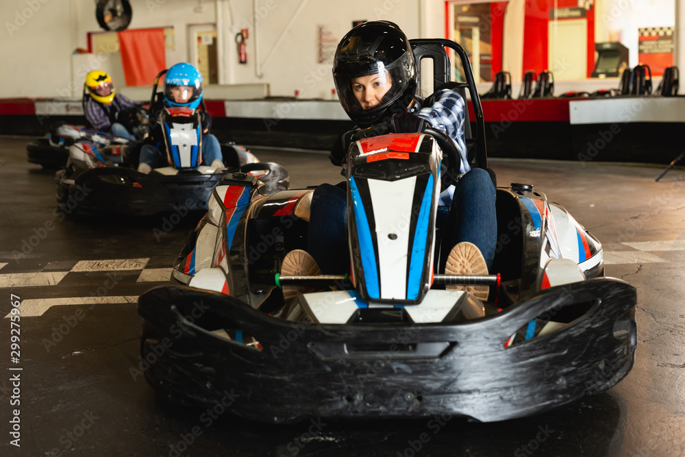 Female driving go-kart car indoor