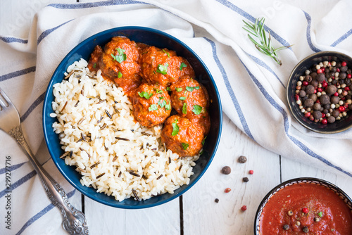 Meatballs with rice and tomato sauce in a bowl