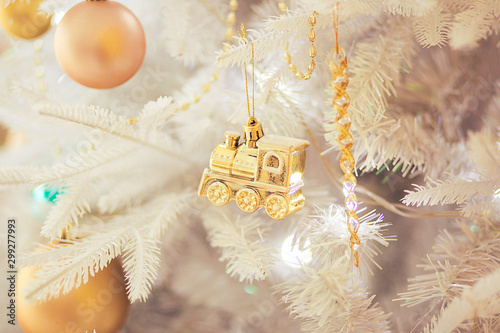 Christmas-tree decoration (golden train) on white christmas tree