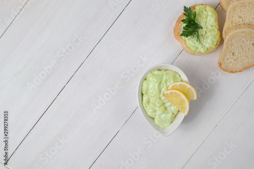 vegetarian avocado sauce in white bowl croutons lemon sandwich on wooden background taste kitchen cooking restaurant breakfast